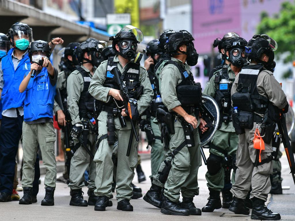 May, 2020: Riot police gather on a road as protesters take part in a pro-democracy rally against the proposed new security law in Hong Kong. Picture: Anthony Wallace