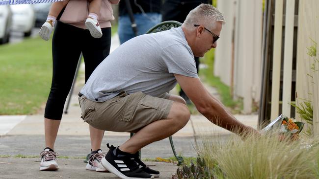 Wellwishers leave floral tributes at the scene. Picture: Andrew Henshaw