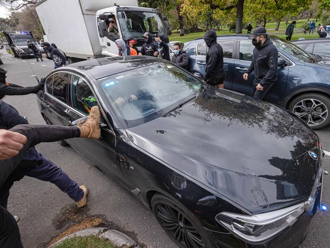 Protesters attack a undercover car. Picture: Jason Edwards