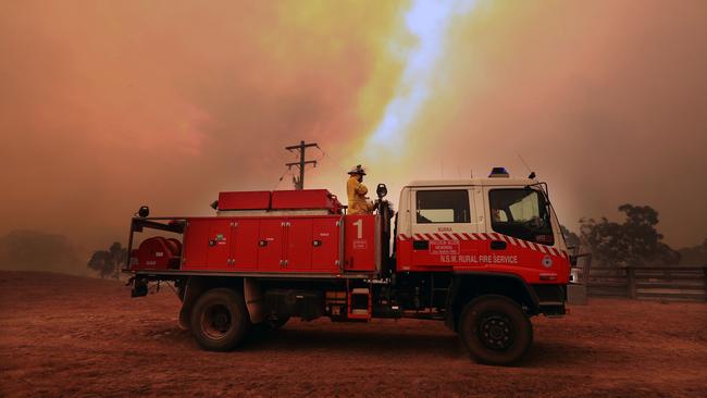 A large fire is burning out of control in the small country area of Bombay, NSW just outside of Braidwood in NSW. RFS volunteers from Carwoola protect property. Picture Gary Ramage