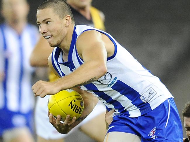 North Melbourne v Richmond. Etihad Stadium. Gavin Urquhart gets tackled by Andrew Collins.