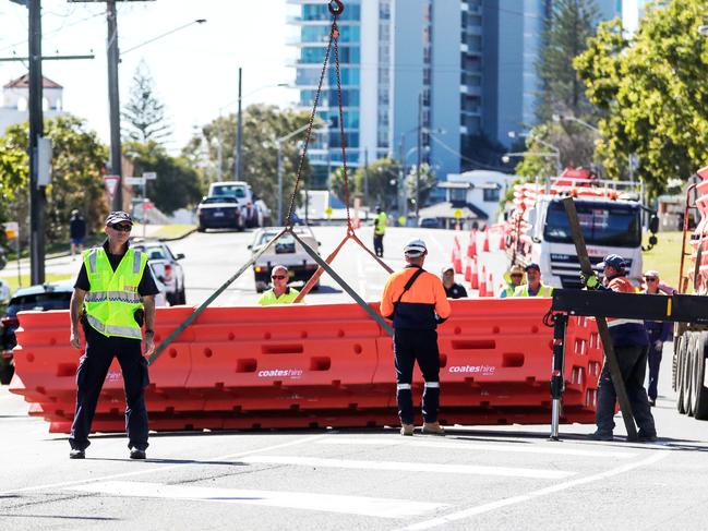 Police observe workers setting up barriers in Dixon Street, Coolangatta. Picture: Nigel Hallett.