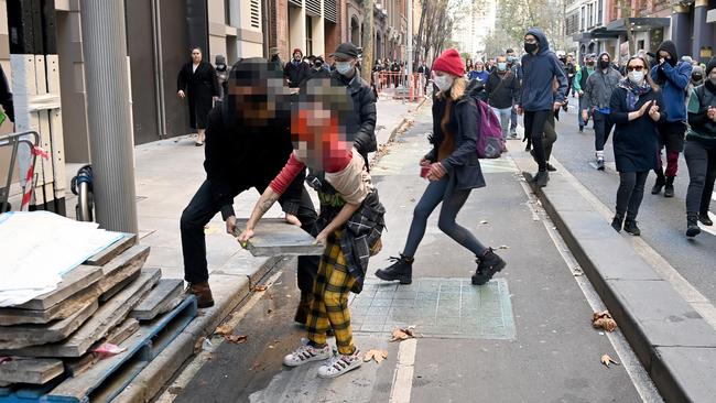 Some of the Blockade Australia activists hurled roadside signs, fencing and even pavers from construction sites onto the road. Picture: NCA NewsWire/Jeremy Piper