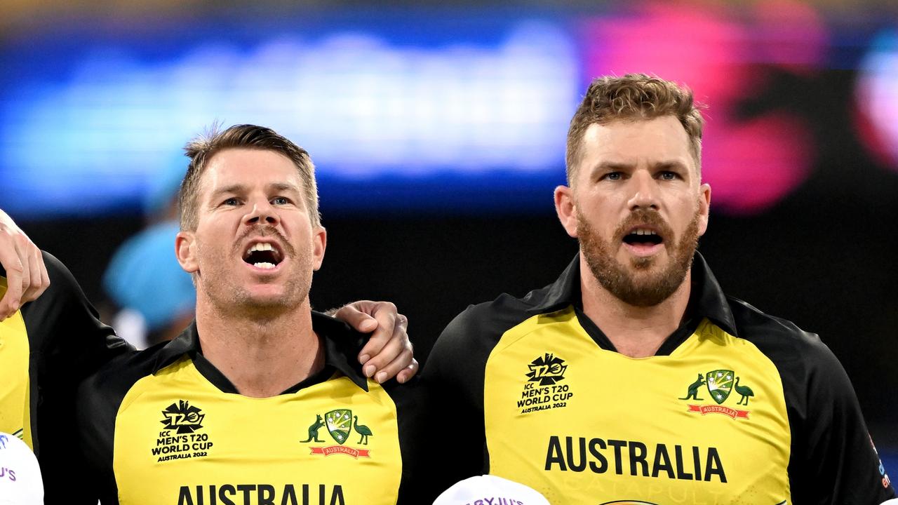 BRISBANE, AUSTRALIA - OCTOBER 31: Glenn Maxwell, David Warner and Aaron Finch of Australia embrace for their national anthem before the ICC Men's T20 World Cup match between Australia and Ireland at The Gabba on October 31, 2022 in Brisbane, Australia. (Photo by Bradley Kanaris/Getty Images)