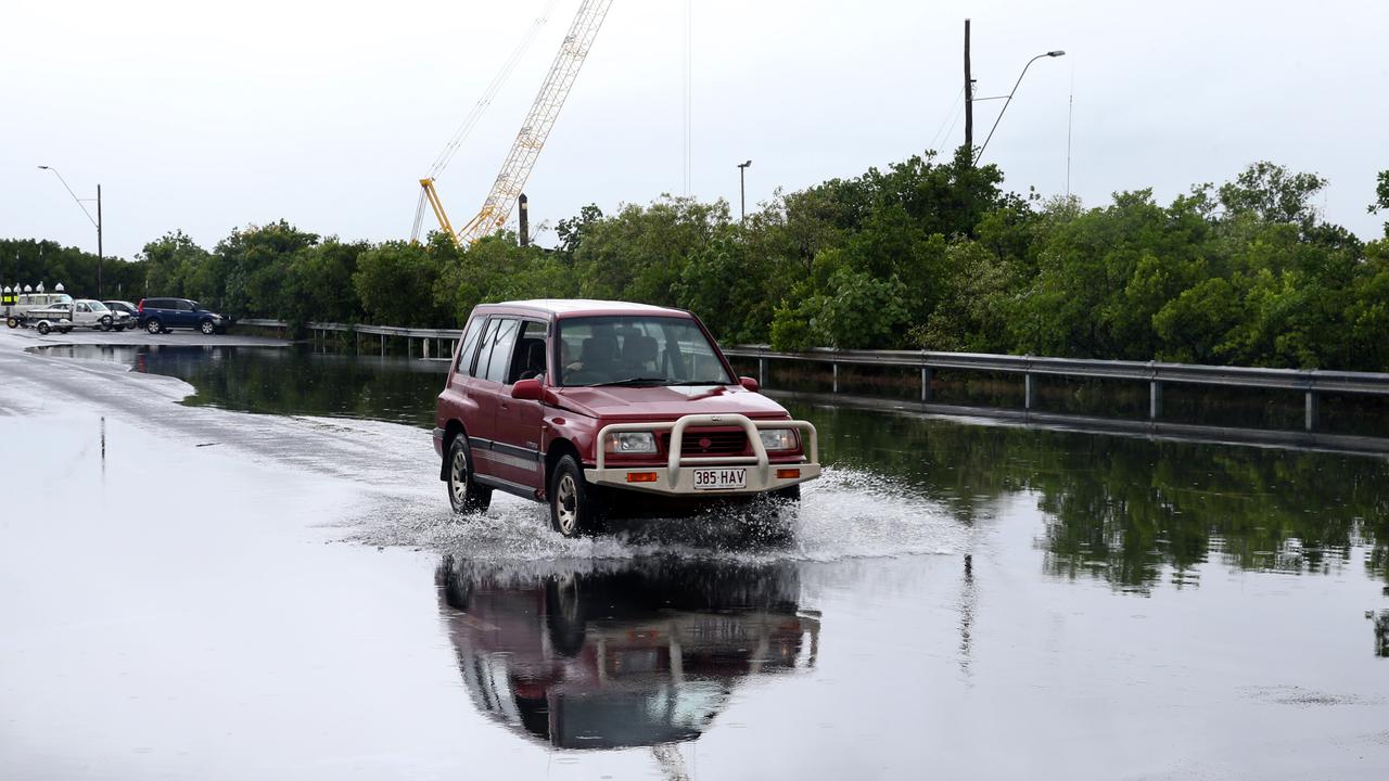 A cra drives through the water over the road at Trawler Base Rd at Portsmith during the high tide PICTURE: ANNA ROGERS