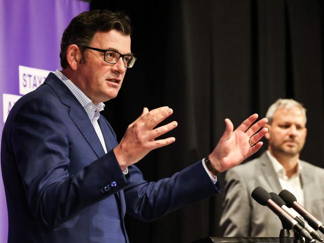 Victorian Premier Daniel Andrews and Victoria’s CMO Brett Sutton in the background. Picture: NCA NewsWire / Ian Currie