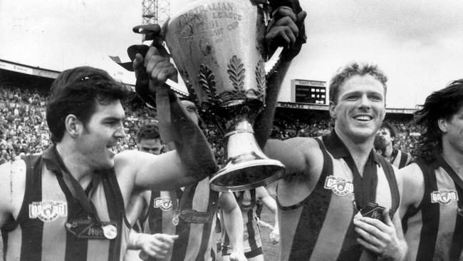 Dermott Brereton (right) lifted five premiership cups but admits the 1991 triumph at Waverley Park ‘isn’t the same’ as his four at the MCG. Picture: News Corp Australia