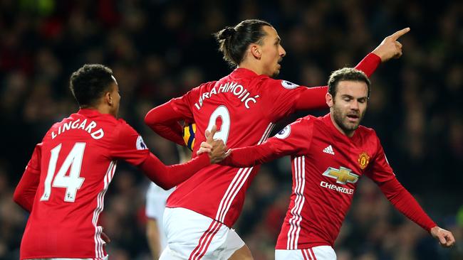 Zlatan Ibrahimovic of Manchester United (L) celebrates scoring his side’s goal.