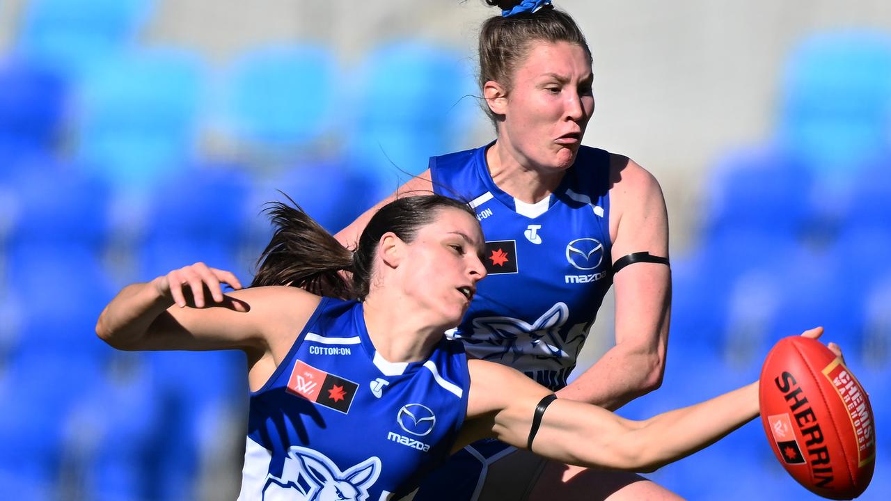 Amy Smith and Tahlia Randall of the Kangaroos compete for the ball.