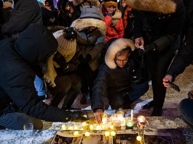 Mourners place candles and photographs outside the Alberta Legislature Building in Edmonton, Alberta. At least 63 Canadians died in the crash. Picture: AP