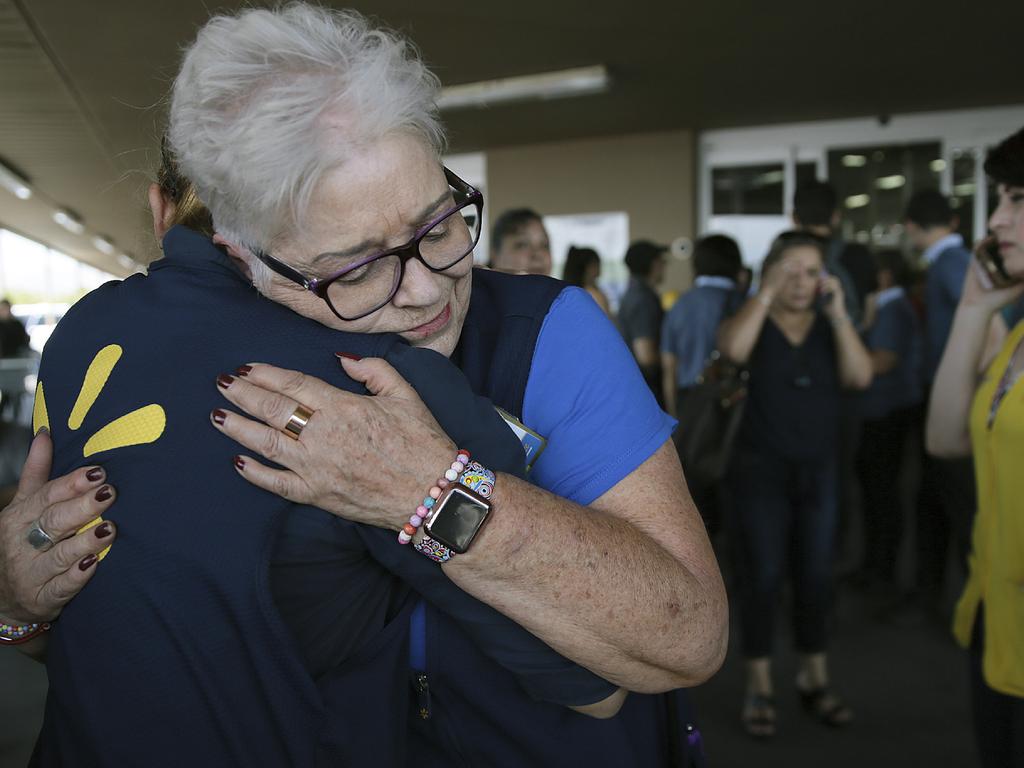 Walmart employees comfort one another after a gunman opened fire. Picture: Mark Lambie/The El Paso Times via AP