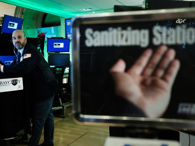 Traders work on the floor of the New York Stock Exchange (NYSE) near a sanitisation station. Picture: Getty