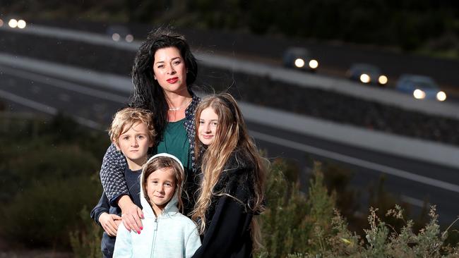 Concerned motorist Michelle Ward, with her children Cormac, Harper, and Charlee on Honeypot Rd above the Southern Expressway last week. Picture: Dylan Coker