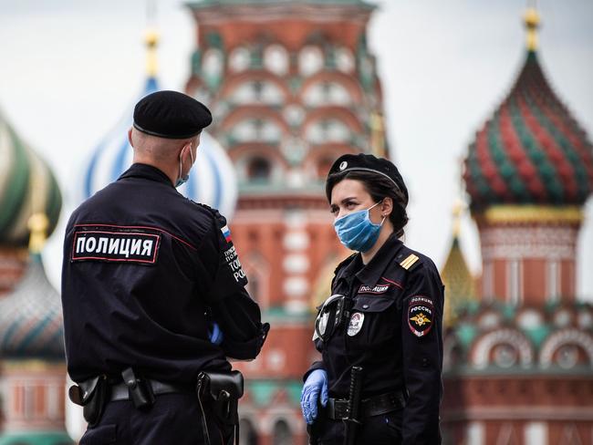 Police officers wearing face masks and gloves patrol Red Square in central Moscow. Picture: AFP