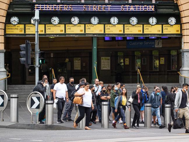 MELBOURNE, MARCH 1, 2022: Commuters flock past Flinders Street Station as Melburnians return to working in the CBD. Picture: Mark Stewart