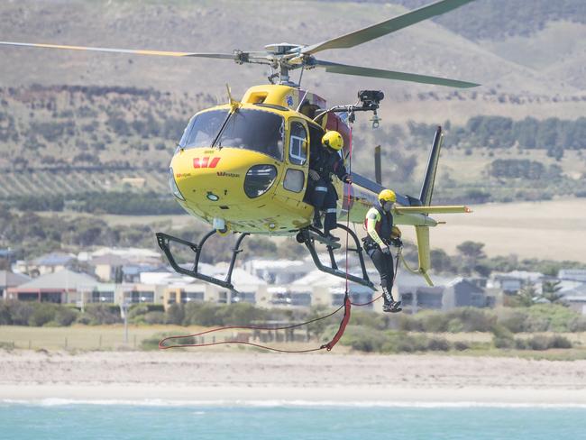 The MedStar helicopter winched the family to safety in a 30-minute operation. Picture: Simon Cross