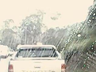 A still shot of the video by Stuart McGavin of a man escaping a police van on the Toowoomba Range.