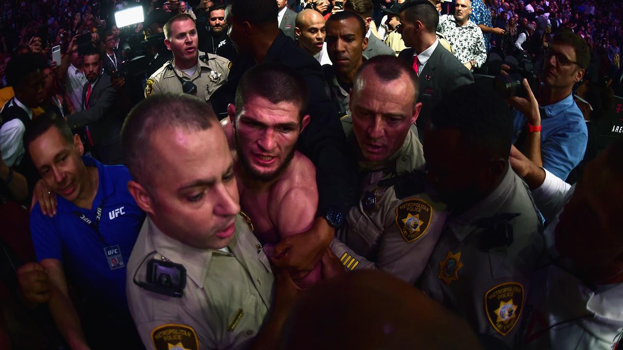 Khabib Nurmagomedov of Russia is escorted out of the arena.