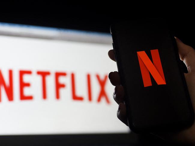 (FILES) In this photo illustration a computer and a mobile phone screen display the Netflix logo on March 31, 2020 in Arlington, Virginia. - Netflix is facing a formidable challenge as it expands into video games to keep the attention of customers in the increasingly competitive world of streaming television. The streaming television leader offered details of its plans to move into games in its latest update confirming cooling growth even as the Silicon Valley giant spins off hit shows. (Photo by Olivier DOULIERY / AFP)