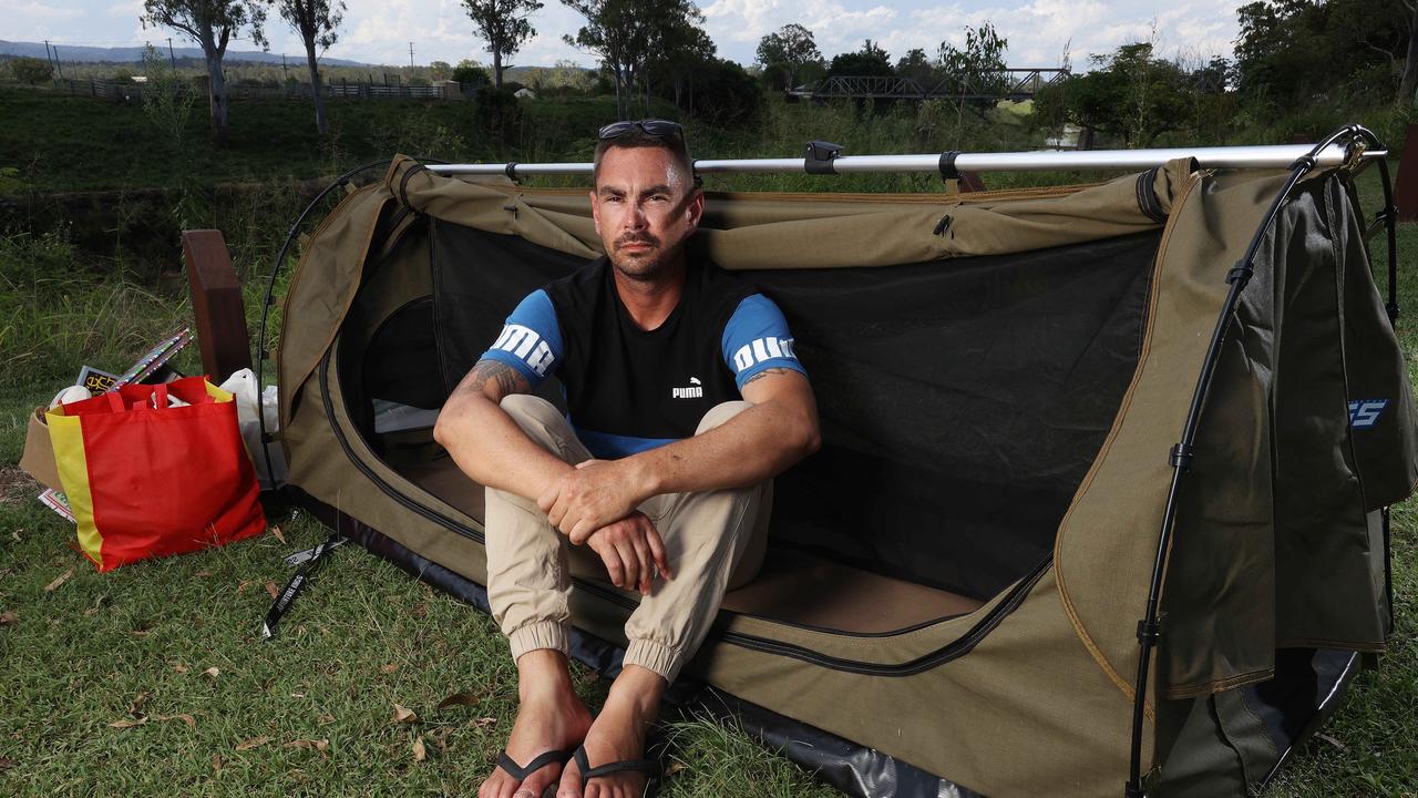 Jay Mobbs, 31, nearly lost his hand in a workplace injury at Toowoomba when it was crushed by a log splitter. He's living in a swag in Gatton unable to work. Picture: Liam Kidston