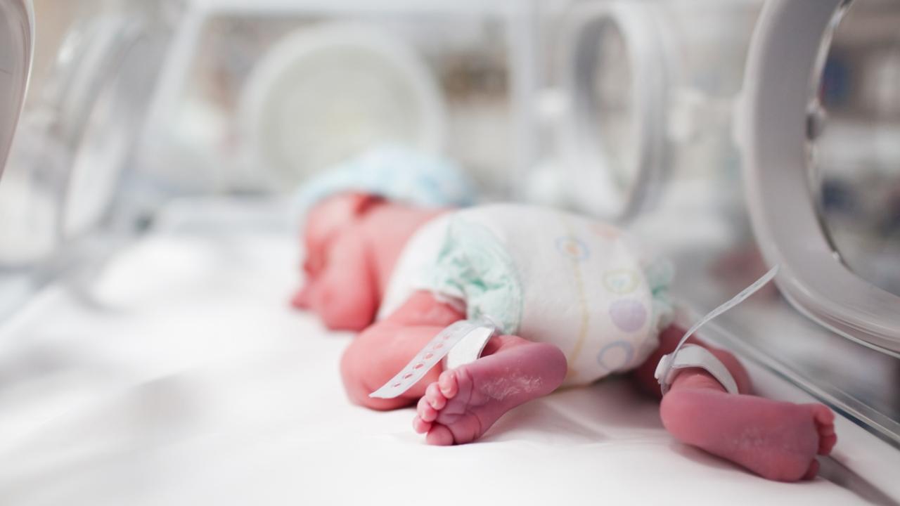 Newborn baby boy covered in vertix inside incubator. iStock Image - Generic