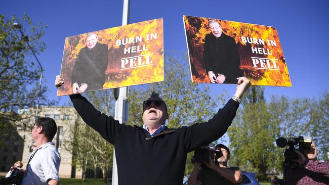 Child sex abuse victim Michael Advocate holds up placards outside the High Court yesterday. Picture: AAP