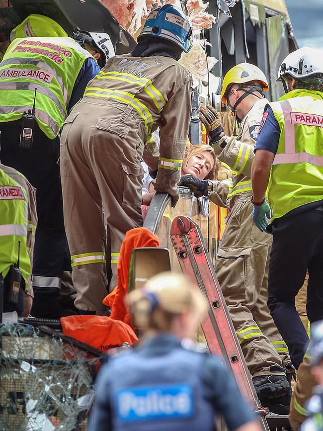 Crews treat a person injured in the crash. Picture: Ian Currie