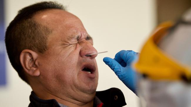 A passenger is tested for COVID-19 at Quito's International Airport as Ecuador. Picture: AFP