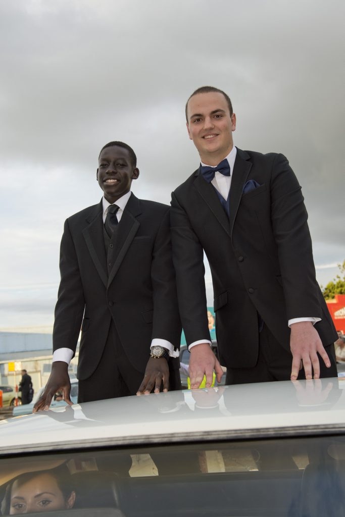 Jok Achiek (left) and Angus Murphy were taken to St Joseph's College Inauguration Ball in the back of a ute. Picture: Kevin Farmer