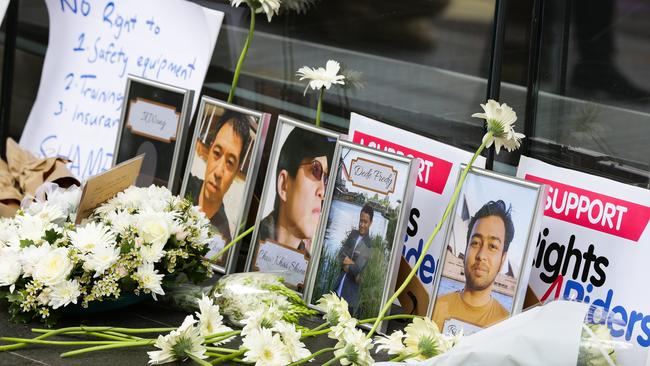 A vigil outside Uber’s Sydney headquarters honoured a number of delivery riders who have died on the job recently. Picture: NCA NewsWire / Gaye Gerard