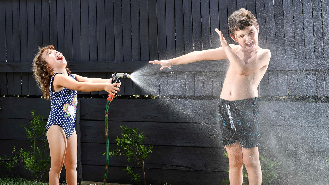 Isabella Bezzina, 4, and brother Connor, 7, cool down yesterday. Picture: John Gass