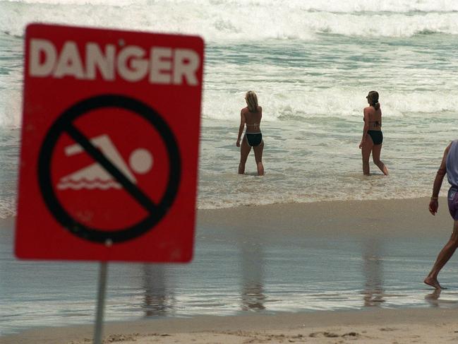 1996 Two girls ignore the danger sign.
