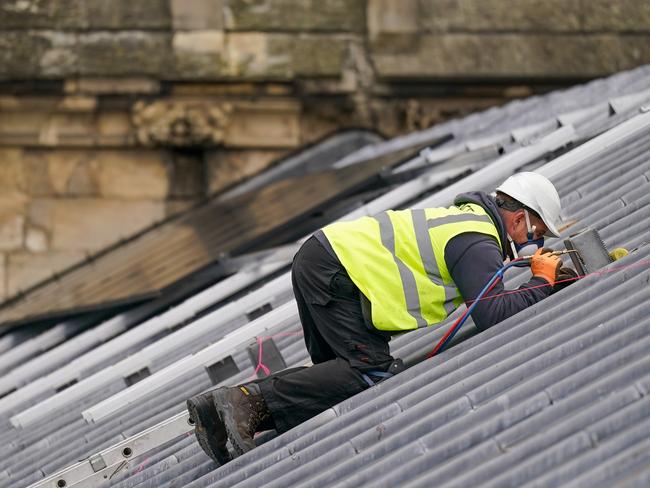 YORK, ENGLAND - OCTOBER 31: Engineers from Associated Clean Technologies work to attach solar panels to the roof of York Minster on October 31, 2024 in York, England. The roof of York Minister is being equipped with 184 solar panels, as a step towards reducing the cathedral's carbon footprint by approximately 13 tonnes of CO2 per year. The panels are expected to generate close to 70,000 kWh annually, or roughly a third of York Minster's total energy consumption. (Photo by Ian Forsyth/Getty Images)