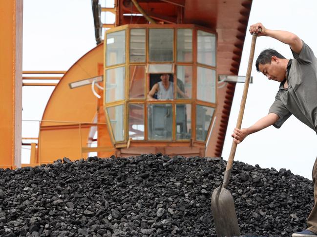 A coal yard worker shovels a load of coal on to the back of a truck in Ningan in Heilongjiang Province, July 5, 2006. China saw sharp growth in energy consumption this year. According to statistics, in the first four months, China's coal consumption rose by 13.8 percent over the same period of last year, coke, 11 percent and electricity, 12.5 percent.