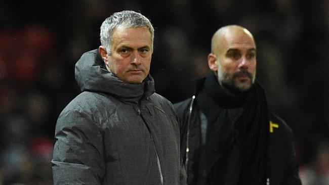 Manchester United's Portuguese manager Jose Mourinho (L) and Manchester City's Spanish manager Pep Guardiola (R).