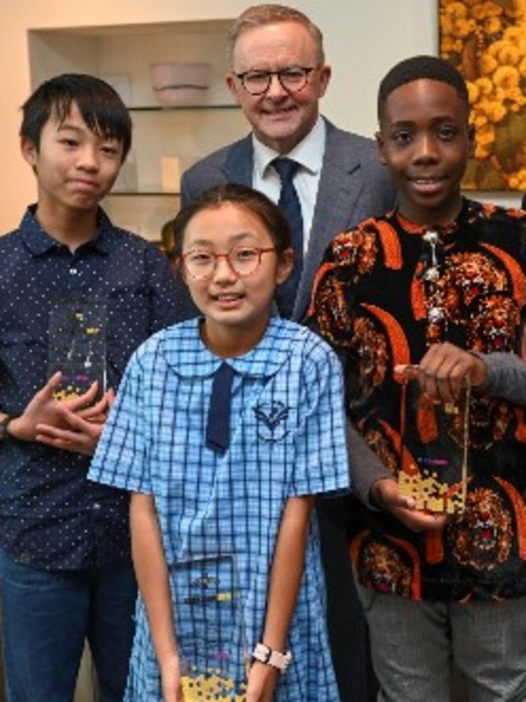 Prime Minister Anthony Albanese with the winners of the 2022 Prime Minister's Spelling Bee, from left, Zachary Cheng, Joanne Lee and Ozi Egesi. Picture: Martin Ollman/NCA NewsWire