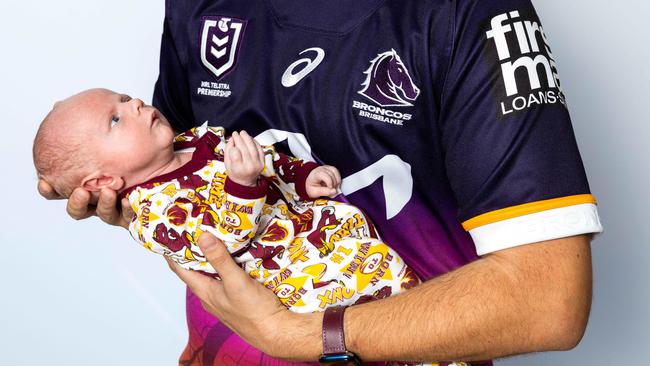 Damian Torrie with baby William, the Broncos’ youngest member. Picture: Richard Walker