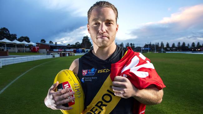 Glenelg footballer Michael Virgin holding a North Adelaide guernsey in honour of his father North Adelaide president Lee Virgin who passed away at Glenelg Oval ACH Group Stadium Tuesday, June,8,2021.Picture Mark Brake