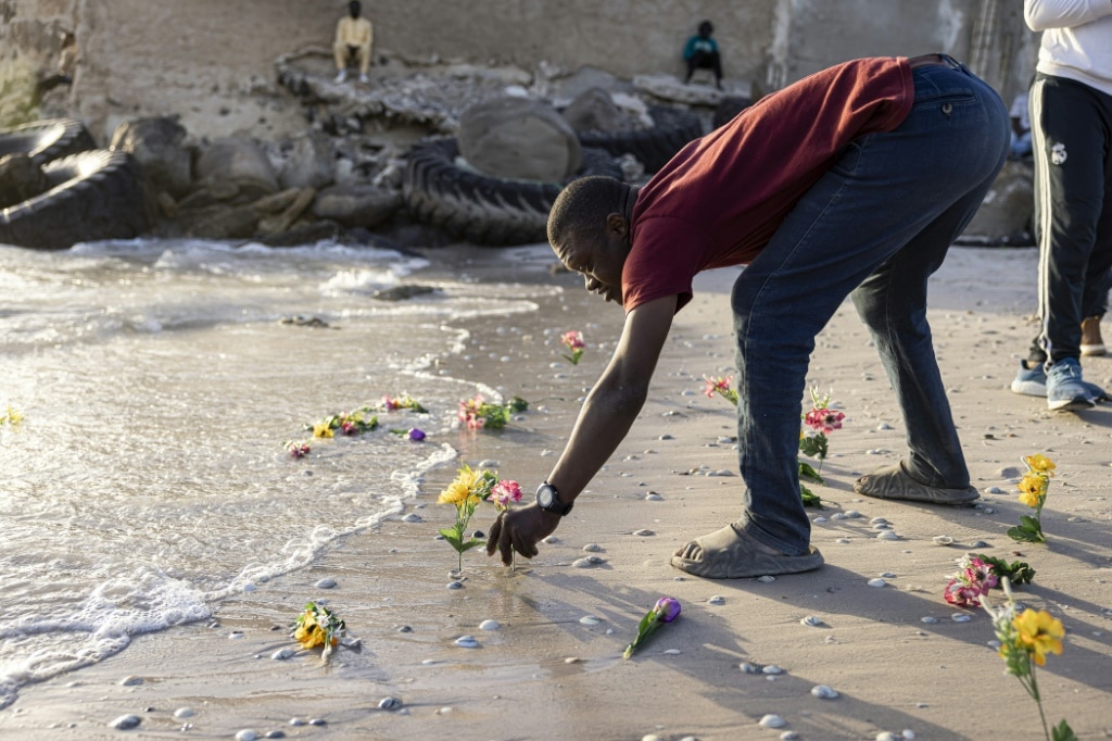 Flowers in the sand: families mourn Senegal migrants lost at sea