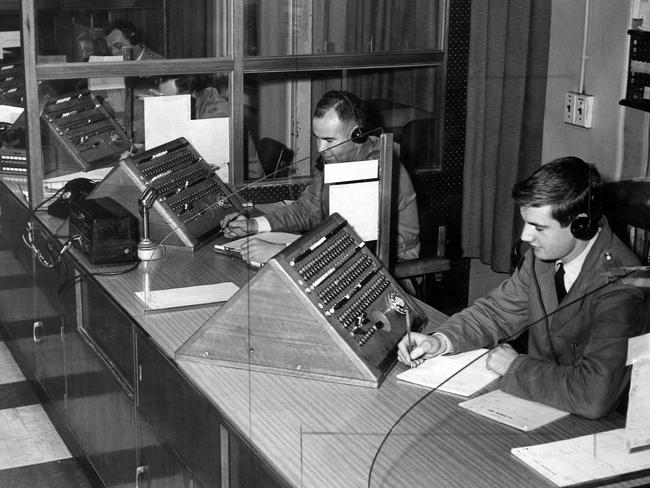 1965: Senior Constable Tom Beswick and Constable Peter Graham at work in the D24 communications centre at the Russell St police HQ in Melbourne. File picture