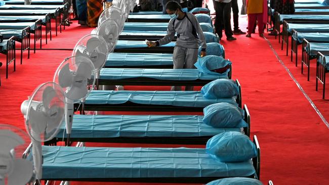 A health worker sanitises bedding facility at a naturopathy Covid-19 coronavirus treatment centre in Chennai, India, on Monday. Picture: AFP