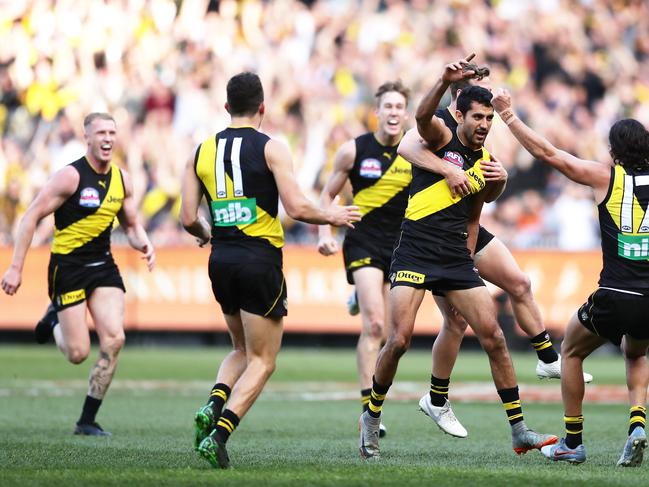 MELBOURNE, AUSTRALIA - SEPTEMBER 28: Marlion Pickett of the Tigers celebrates with team mates after kicking a goal during the 2019 AFL Grand Final match between the Richmond Tigers and the Greater Western Sydney Giants at Melbourne Cricket Ground on September 28, 2019 in Melbourne, Australia. (Photo by Matt King/AFL Photos/via Getty Images )