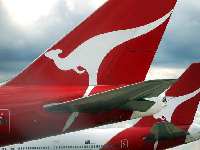 Generic of flying kangaroo emblem on tail of Qantas aircraft at Sydney Airport, with company announcing the cut of 1750 staff during downturn of International operations.