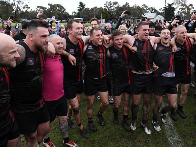 Hampton Park players sing the club song on the ground after defeating Clayton.