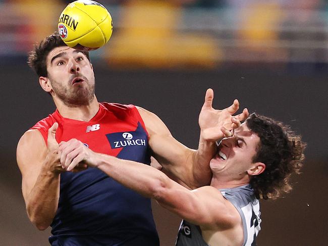 Christian Petracca is made to work for the ball by Darcy Byrne-Jones. Picture: Michael Klein