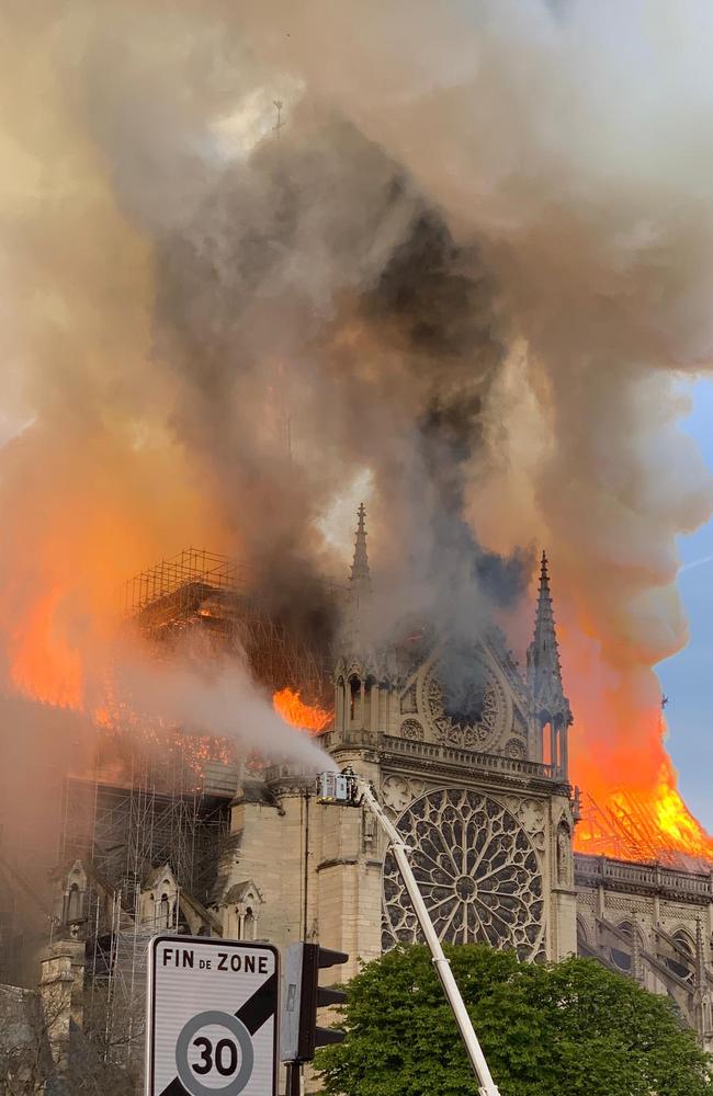 Flames and smoke are seen billowing from the roof at Notre-Dame Cathedral in Paris on April 15, 2019. (Photo by Patrick ANIDJAR / AFP)