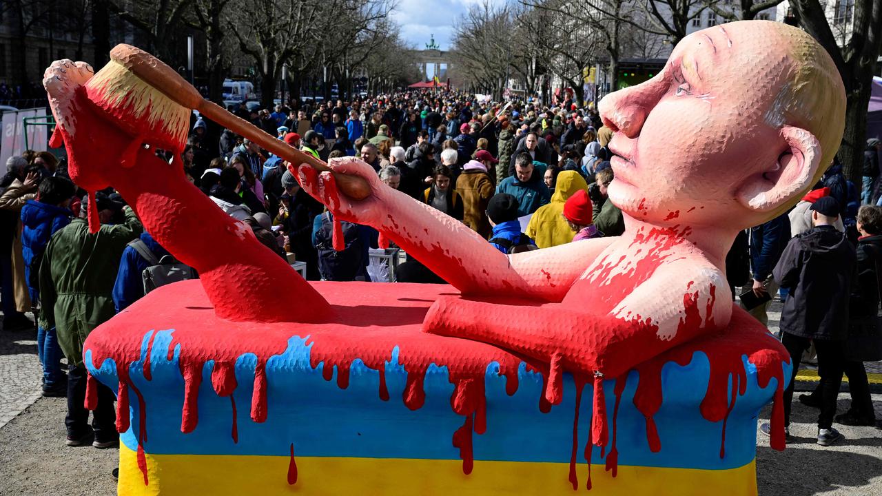 An effigy of Vladimir Putin bathing in blood stands before the Russian embassy in Berlin, as voters queue for Russia’s presidential election. Picture: Tobias Schwartz/AFP