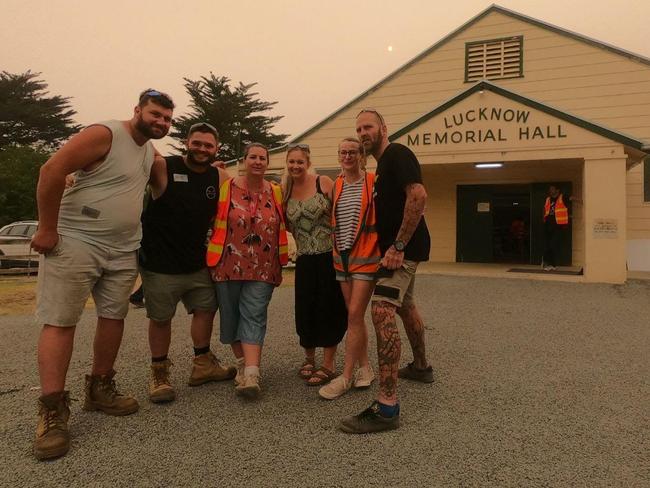 Tradies Robert Johnstone (second left) and Nathan Alison (far right) have been helping fire affected Victorians fix their properties for free. Picture: Supplied