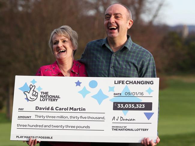 Big winners ... Carol and David Martin pose with their £33 million cheque. Picture: Andrew Milligan/PA