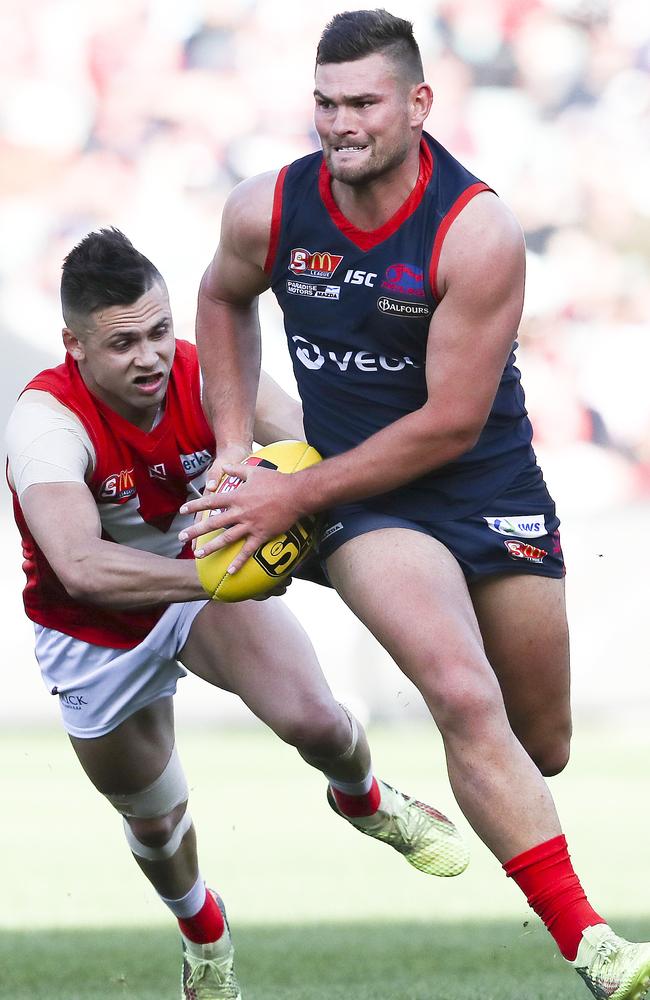 Norwood’s Mitch Grigg breaks free of North’s Robbie Young in the grand final. Picture Sarah Reed